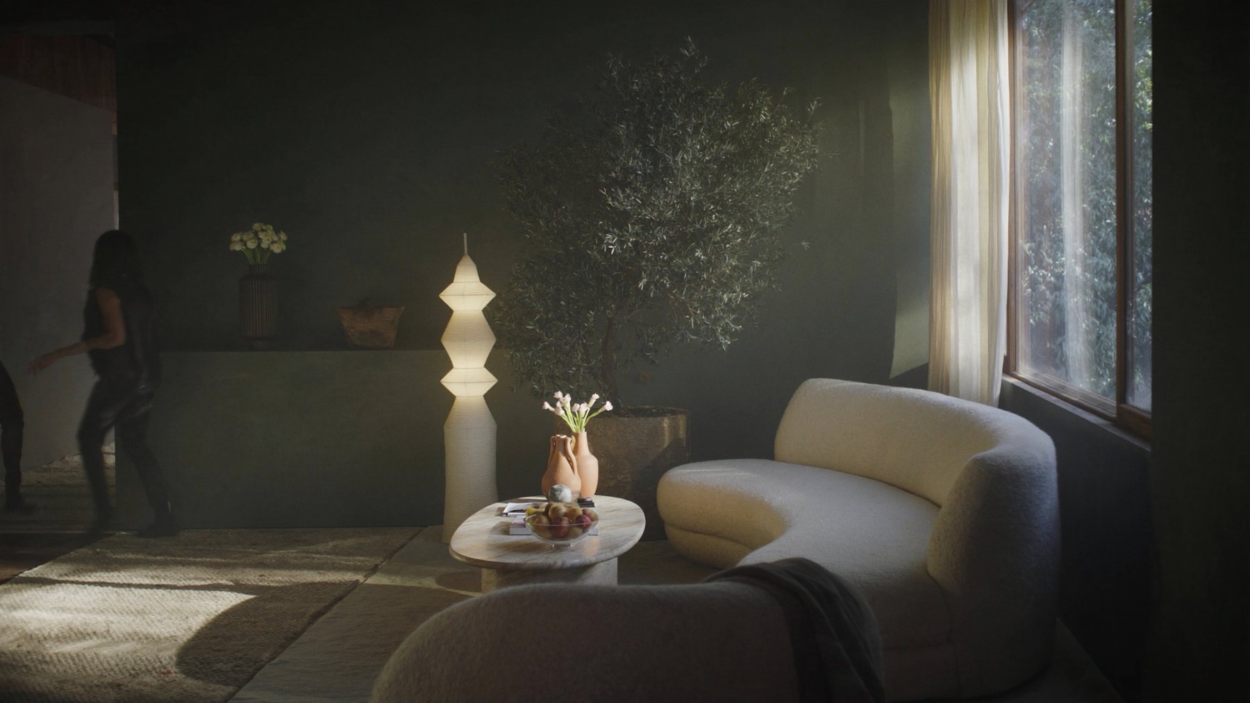 Calm modern living room with olive plaster wall, ivory boucle sofa and travertine coffee table
